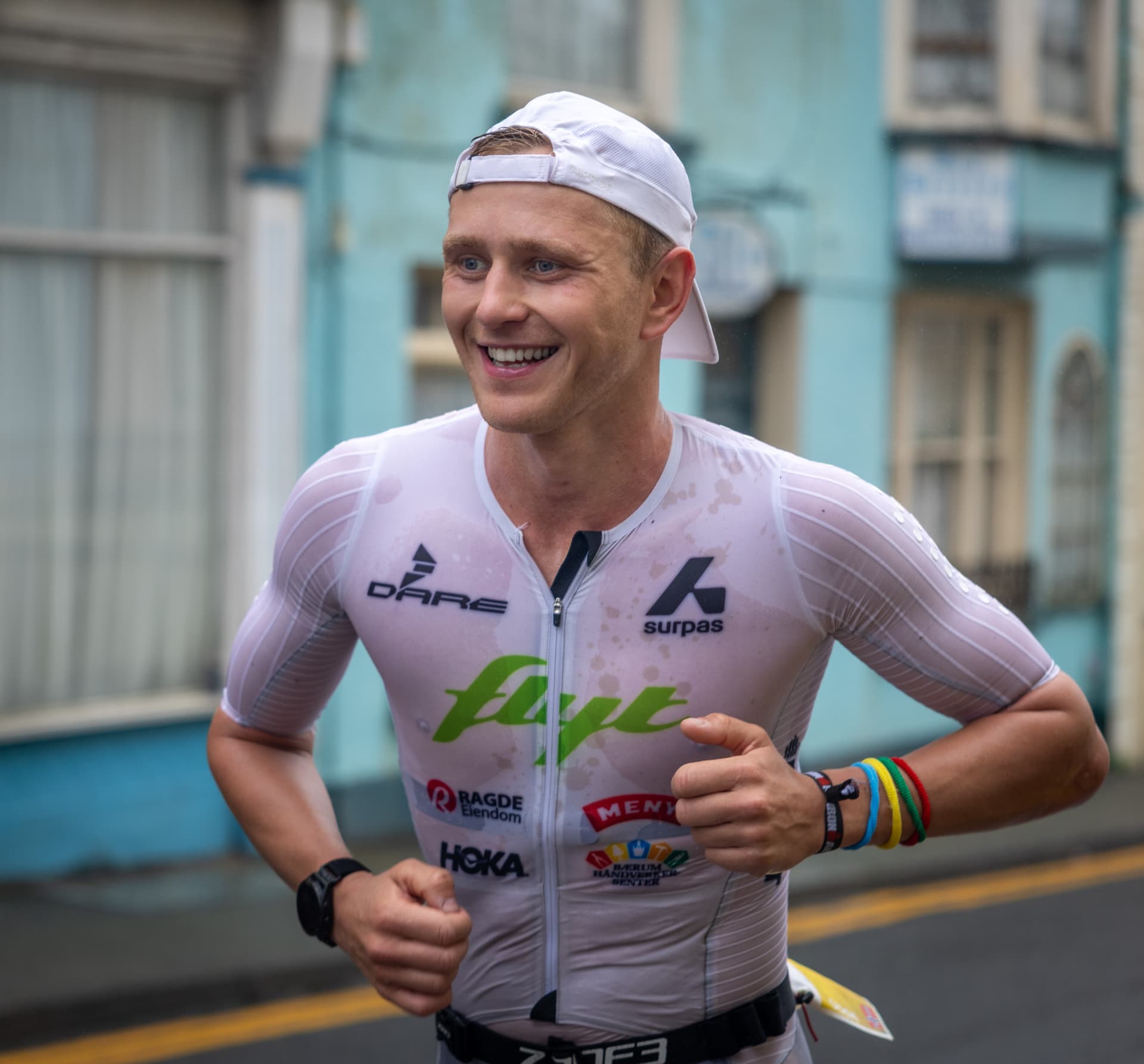 Kristian Grue smiling on the run through the streets during Ironman Wales 2026